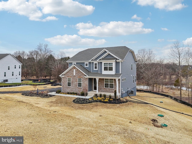 view of front of property featuring a front yard and covered porch