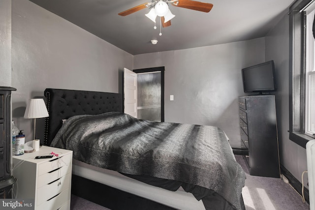 carpeted bedroom featuring radiator and ceiling fan