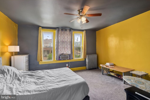 bedroom featuring radiator heating unit, light carpet, ceiling fan, and cooling unit