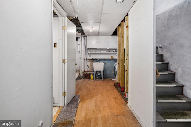 hall featuring light hardwood / wood-style floors and sink