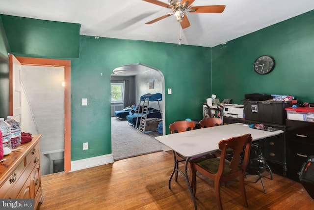 dining space with ceiling fan and hardwood / wood-style floors