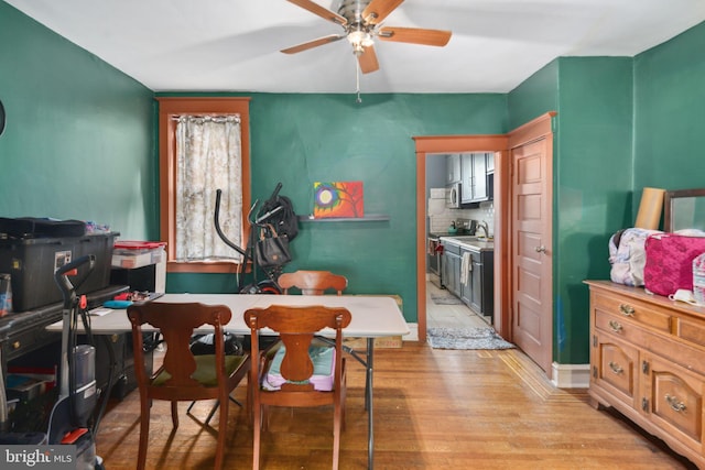 dining area with ceiling fan and light hardwood / wood-style flooring