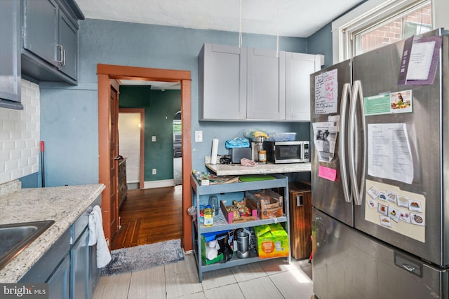 kitchen featuring light hardwood / wood-style floors, appliances with stainless steel finishes, and sink