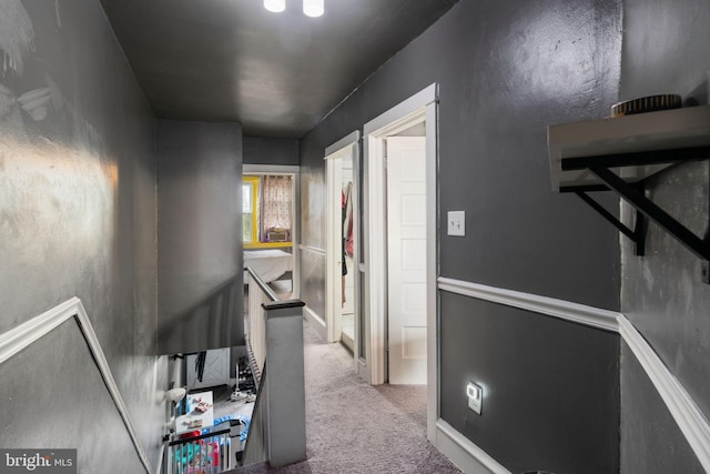 hallway featuring light colored carpet