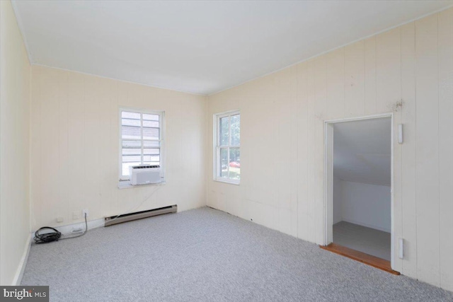 carpeted empty room featuring cooling unit and baseboard heating