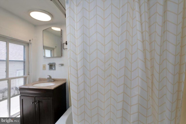 bathroom featuring a shower and vanity