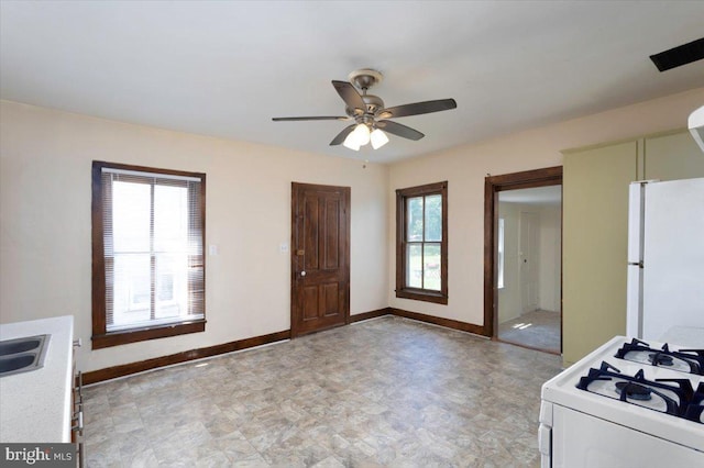 kitchen featuring sink, white appliances, and ceiling fan