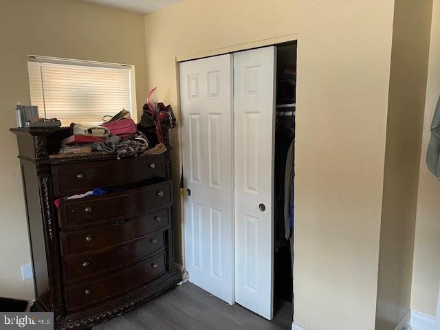 bedroom featuring dark hardwood / wood-style flooring and a closet