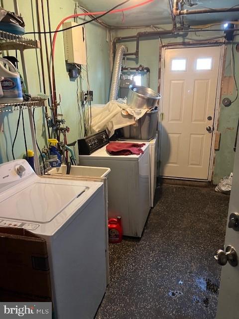 clothes washing area with water heater and independent washer and dryer