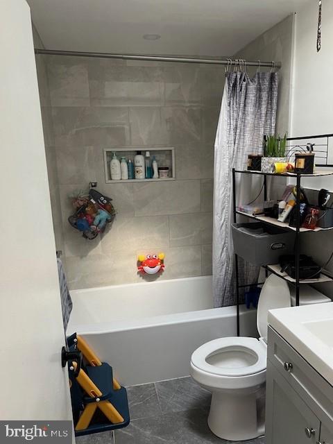 full bathroom with vanity, toilet, and shower / bath combo with shower curtain