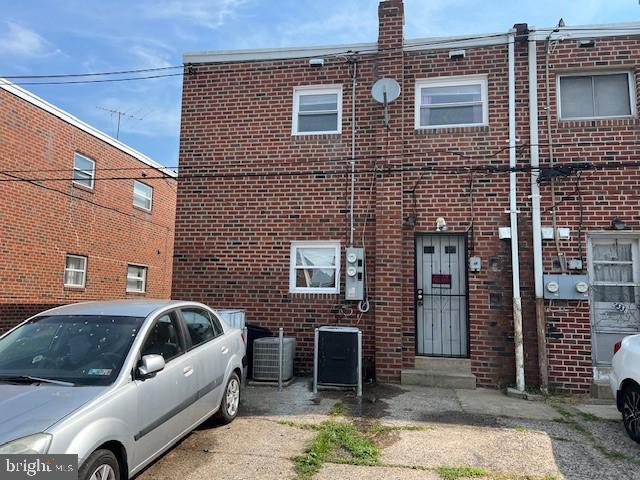 rear view of property with central AC unit