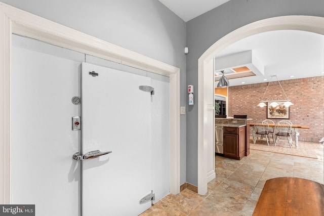 entrance foyer with brick wall