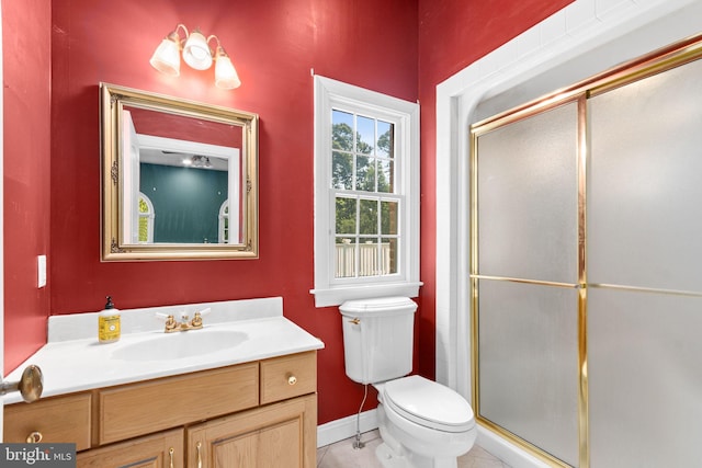 bathroom with vanity, toilet, and walk in shower