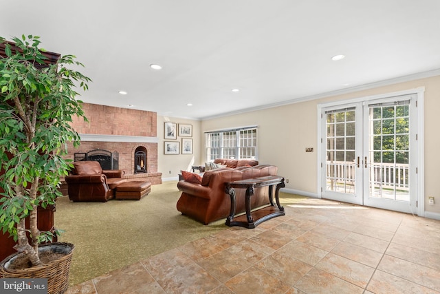 living room featuring crown molding, a wealth of natural light, a fireplace, and french doors