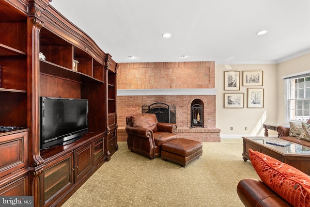 carpeted living room featuring a brick fireplace and crown molding