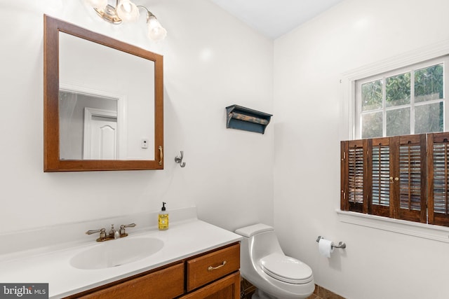 bathroom featuring vanity and toilet