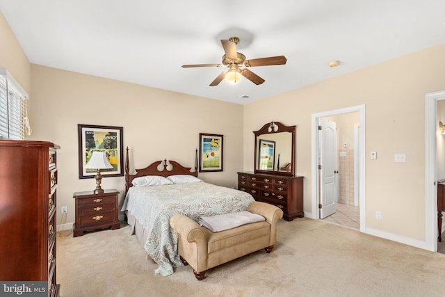 carpeted bedroom featuring ceiling fan and ensuite bathroom