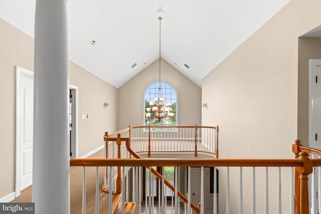 interior space with high vaulted ceiling and an inviting chandelier