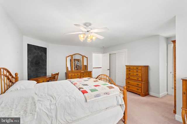 carpeted bedroom featuring ceiling fan and a closet