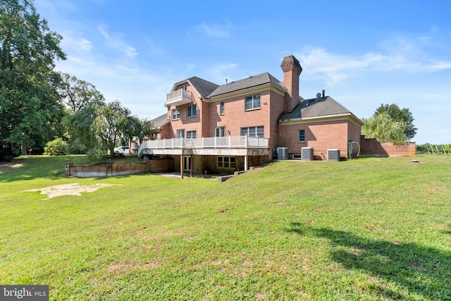 rear view of property with a yard and central AC