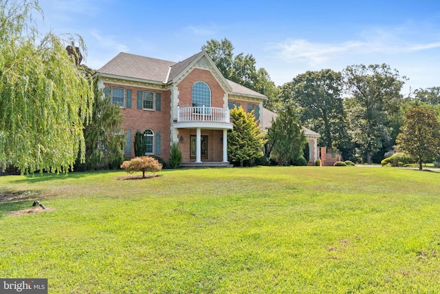 exterior space with a lawn and a balcony