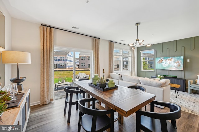 dining room featuring hardwood / wood-style flooring and a chandelier