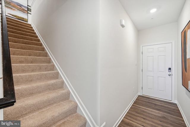 stairs featuring hardwood / wood-style flooring