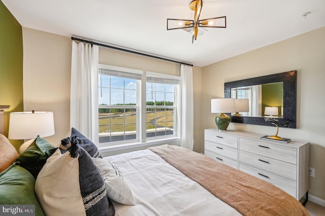 bedroom featuring a notable chandelier