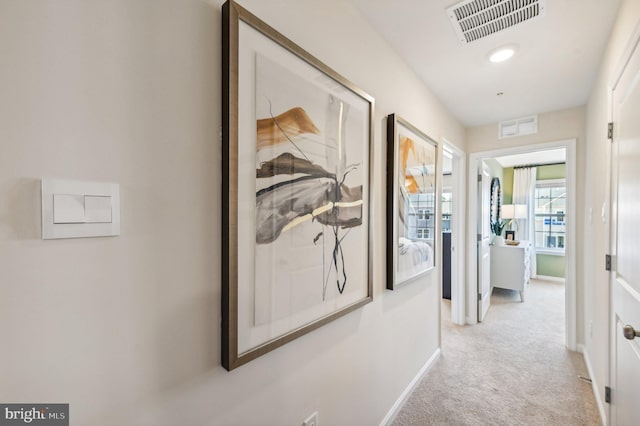 corridor featuring light colored carpet