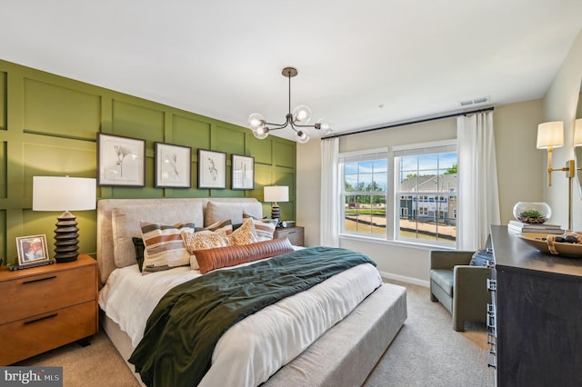 bedroom featuring light carpet and an inviting chandelier