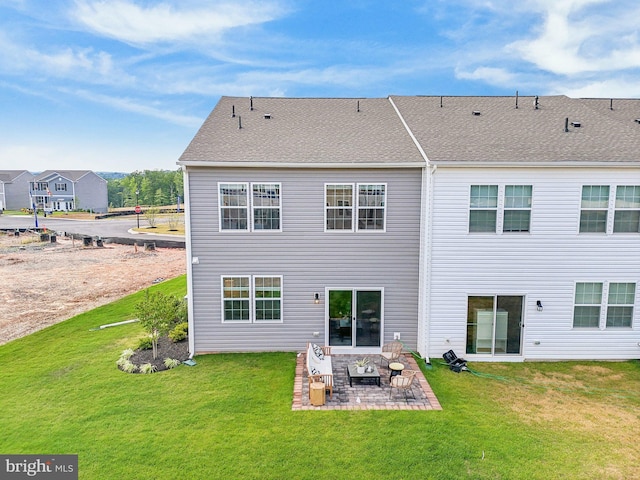 back of house with a lawn and a patio