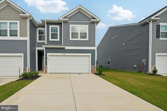 view of front of house featuring a garage and a front lawn