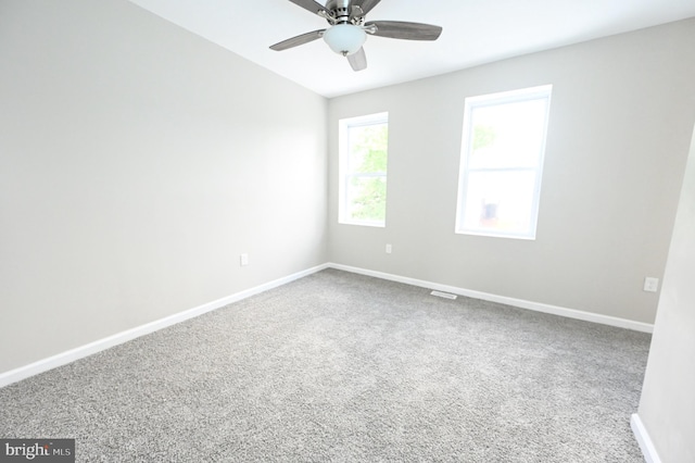 carpeted spare room with ceiling fan