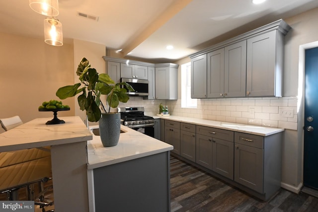 kitchen featuring gray cabinetry and appliances with stainless steel finishes