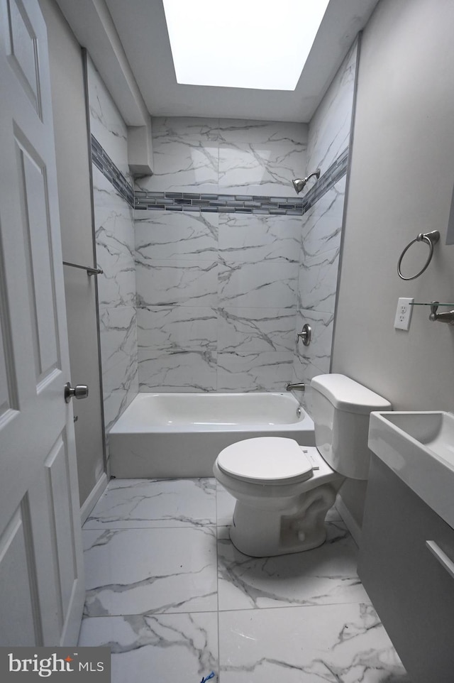 full bathroom with tiled shower / bath combo, vanity, toilet, and a skylight