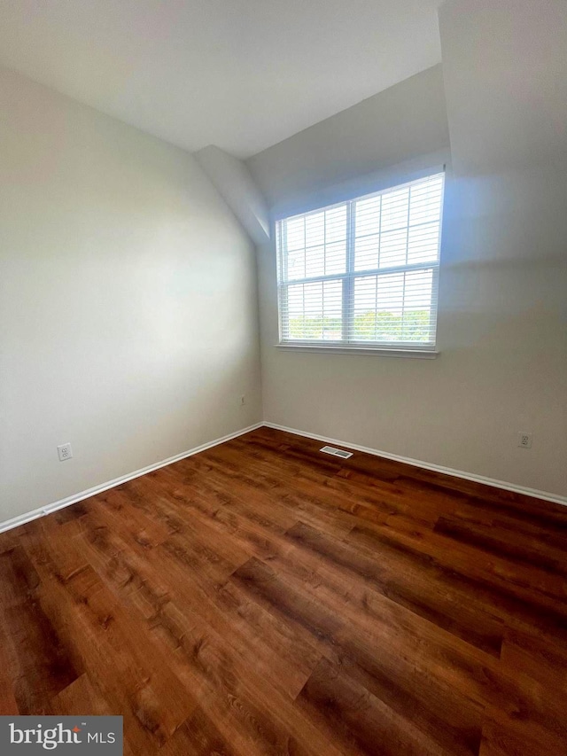 unfurnished room with dark hardwood / wood-style flooring