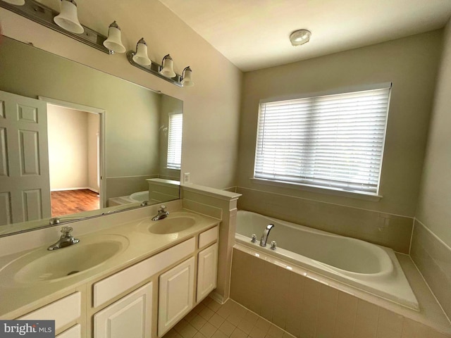 bathroom with vanity, tiled bath, and tile patterned floors