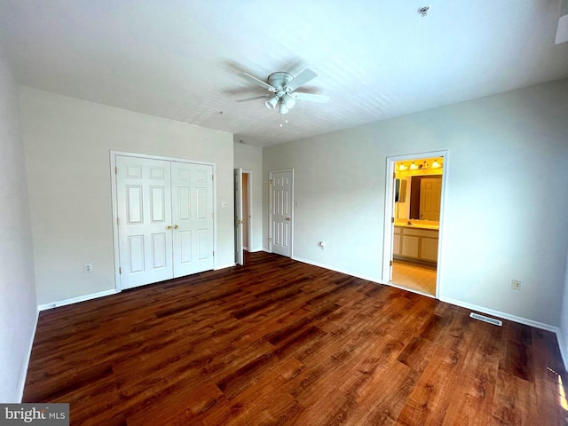 unfurnished bedroom featuring ceiling fan, hardwood / wood-style floors, and ensuite bath