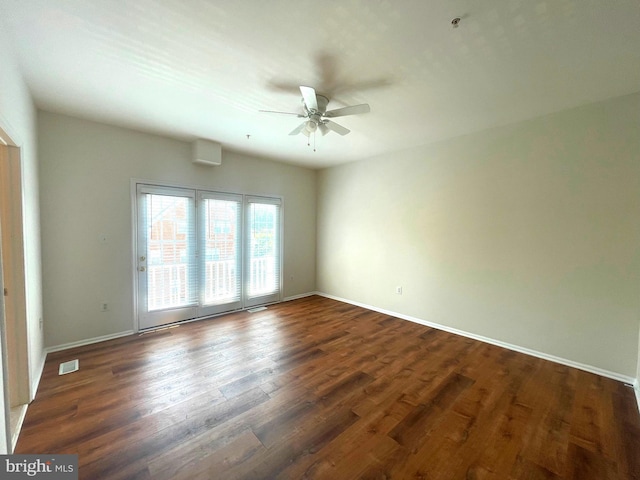 empty room with ceiling fan and dark hardwood / wood-style floors