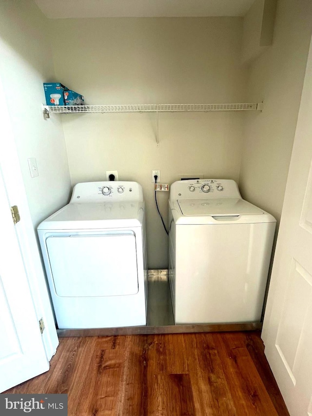 laundry room featuring washing machine and dryer and dark hardwood / wood-style floors