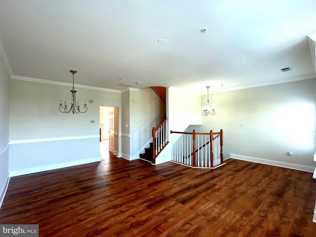 unfurnished room featuring dark hardwood / wood-style flooring, crown molding, and a chandelier