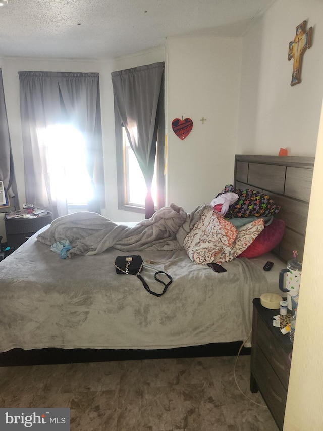 bedroom featuring a textured ceiling and carpet flooring