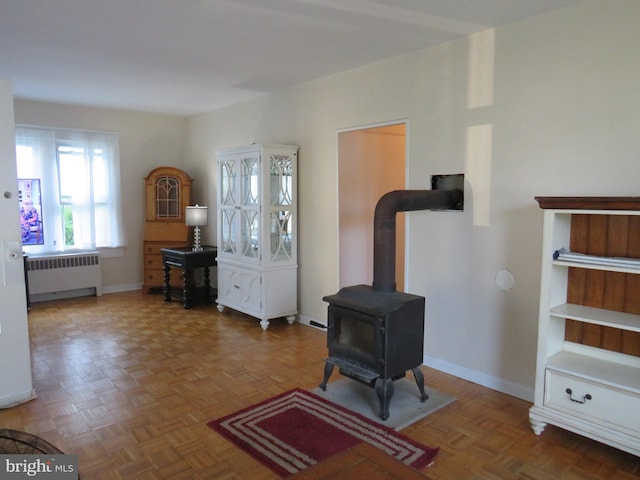 interior space featuring radiator, parquet floors, and a wood stove