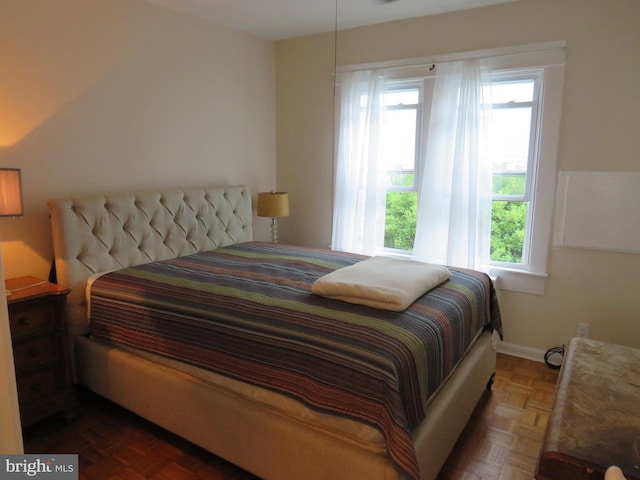 bedroom with dark parquet floors