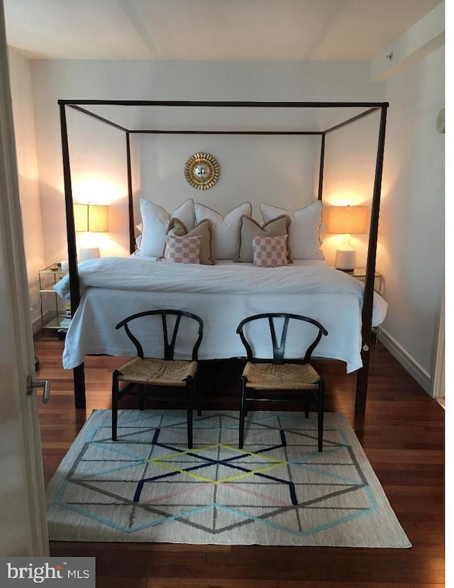 bedroom with dark hardwood / wood-style flooring