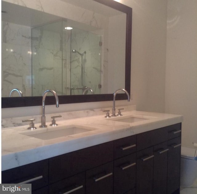 bathroom featuring vanity and a shower with door