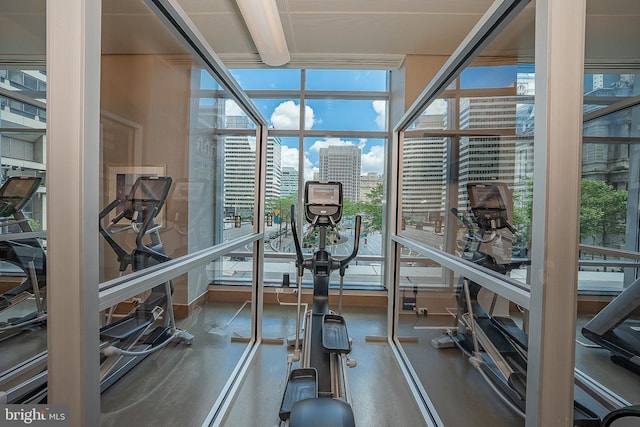 gym with a wall of windows