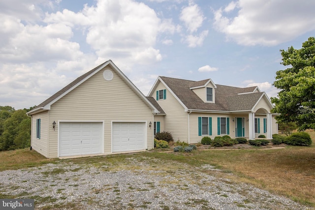 cape cod house featuring a garage