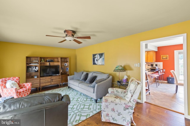 living room with ceiling fan and hardwood / wood-style floors