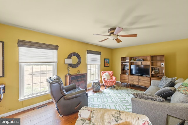 living room with ceiling fan and wood-type flooring